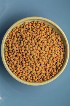 a bowl filled with lots of food on top of a blue table