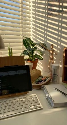 an open laptop computer sitting on top of a white desk