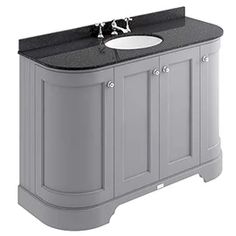 a white sink sitting under a mirror next to a gray vanity with black counter top