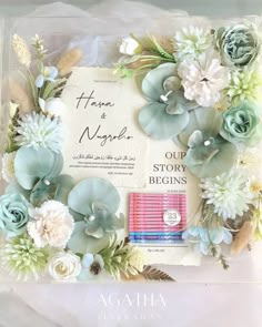 the wedding card is decorated with flowers and leaves, including succulents on it