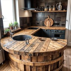 a kitchen with an island made out of wooden barrels