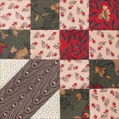 a patchwork quilt with red and green flowers