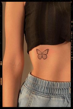 a woman with a butterfly tattoo on her stomach