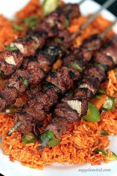 some meat and rice on a white plate