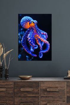 an orange and blue octopus in the ocean with water droplets on it's tentacles