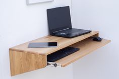 a laptop computer sitting on top of a wooden desk