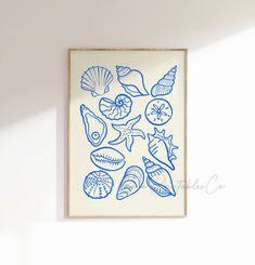 a blue and white painting hanging on the wall