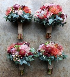 four bouquets of flowers are arranged on the ground