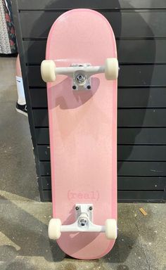 a pink skateboard with white wheels on display