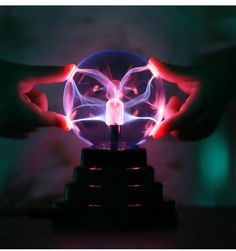 a person holding a glowing ball in their hands