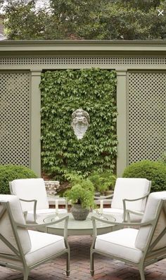 an outdoor patio with white chairs and tables