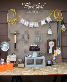 a table topped with a cake and lots of tools