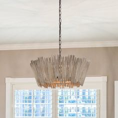 a chandelier hanging over a dining room table