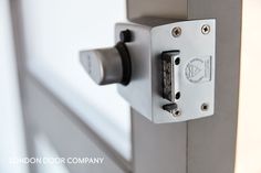 a close up of a door handle on a white door