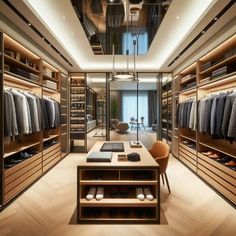 a large walk in closet with lots of clothes and shoes on the shelves next to it