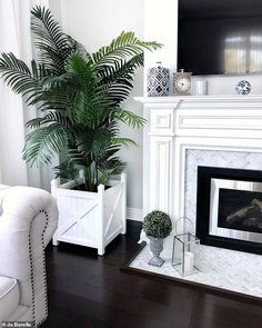 a living room filled with furniture and a fire place in front of a painting on the wall