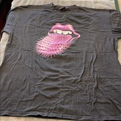 a t - shirt with a pink tongue on it