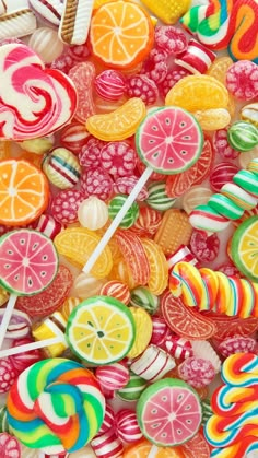 colorful candies and lollipops are arranged together