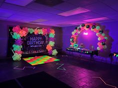 a birthday party with neon lights and balloons