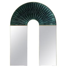 an arch shaped mirror is shown against a white background with the reflection of two mirrors in it