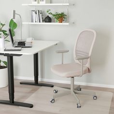 a white desk chair sitting next to a laptop computer