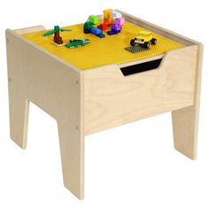 a wooden toy table with legos on it