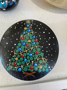 a painted christmas tree on a black plate