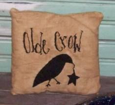 an olde crow pillow sitting on the floor