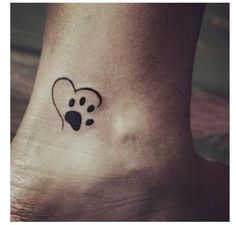 a dog paw with a heart tattoo on the ankle