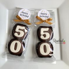 two chocolate covered birthday cookies in cellophane wrappers with the number five on them