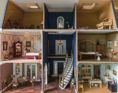 the inside of a doll house with stairs and furniture