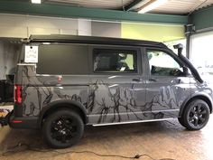 an suv is parked in a garage with its doors open