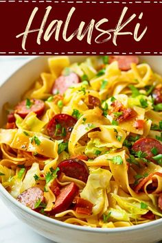 a bowl filled with pasta and sausage on top of a table