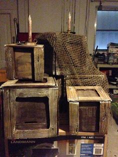 an old wooden stove sitting on top of a table next to a pile of boxes