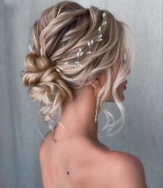 a woman with blonde hair wearing a wedding hairstyle