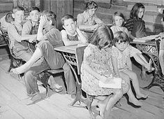 black and white photograph of children sitting at desks