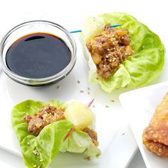 three lettuce wraps with dipping sauce on the side and another wrap filled with food