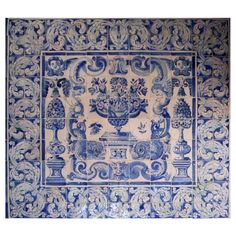 a blue and white tile with an ornate design