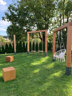 an outdoor area with swings and benches in the grass