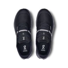 a pair of black shoes with white lettering on the side and grey laces around the sole