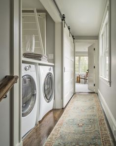 a washer and dryer are in the hallway