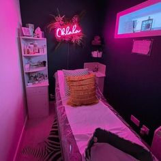 a bed room with a neon sign above it and a pink light on the wall