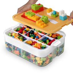 a plastic container filled with lots of colorful legos