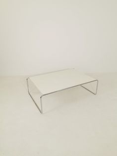 a white coffee table sitting on top of a white floor