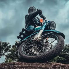 a man riding on the back of a blue motorcycle