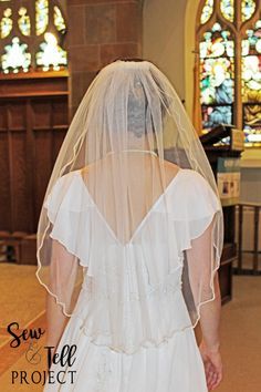 the back of a bride's veil as she walks down the aisle