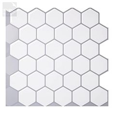 a white hexagonal tile pattern on a wall