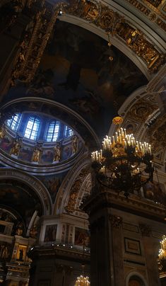 the interior of a church with chandeliers and stained glass windows