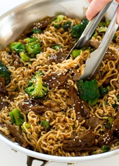 broccoli, beef and noodles with sesame seeds in a skillet ready to be eaten