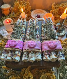 an assortment of soaps with candles in the background